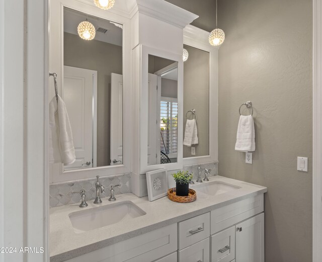 full bathroom with visible vents, a sink, and double vanity