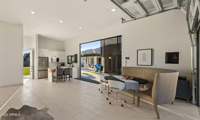 dining area with a high ceiling and electric panel