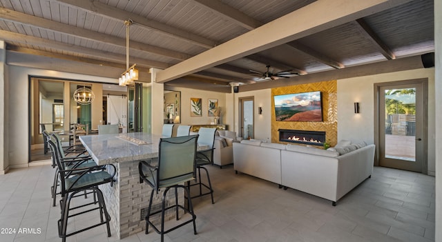 dining space with beam ceiling, ceiling fan, and wood ceiling