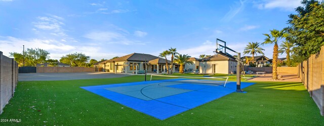 view of basketball court with a yard, community basketball court, fence, and a residential view