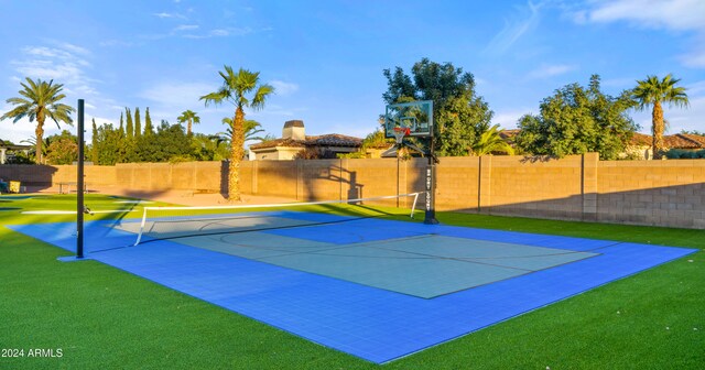 view of sport court featuring a lawn and tennis court