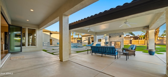 view of patio / terrace featuring a ceiling fan and a fenced in pool