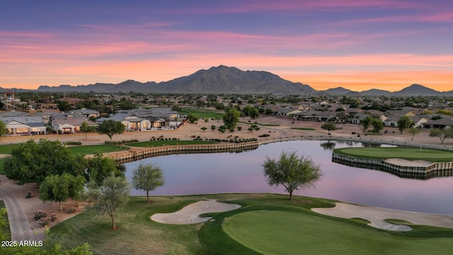 view of property's community with a residential view, golf course view, and a water and mountain view