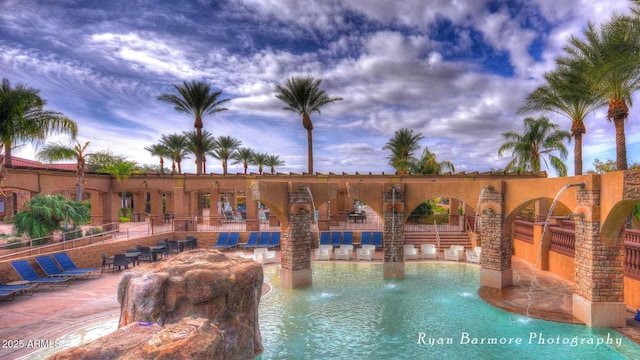 view of swimming pool with a patio area and fence