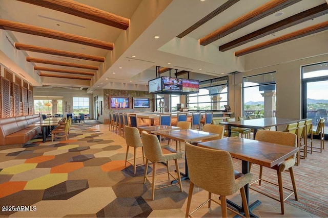 carpeted dining room featuring beam ceiling and recessed lighting