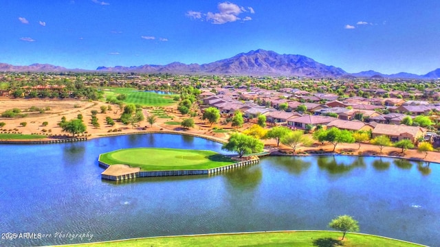 birds eye view of property with a water and mountain view