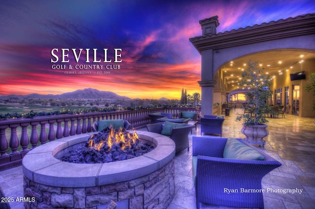 view of patio / terrace featuring a fire pit and a mountain view