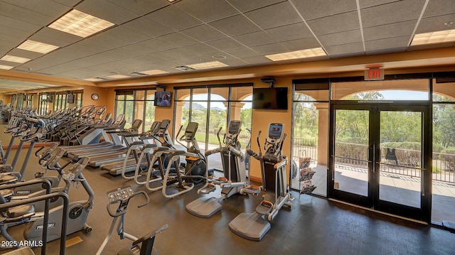 gym with french doors, a drop ceiling, and visible vents