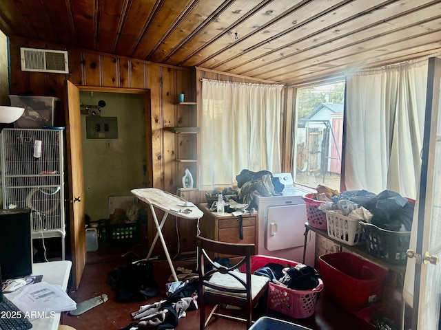 misc room with wooden ceiling, wooden walls, visible vents, and washer and clothes dryer