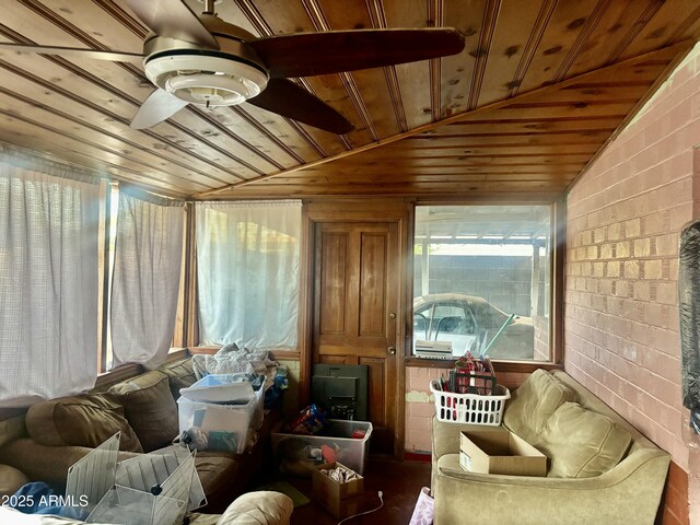 interior space featuring wooden ceiling, a ceiling fan, and vaulted ceiling