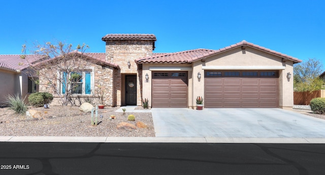 mediterranean / spanish-style house featuring an attached garage, stone siding, a tiled roof, driveway, and stucco siding