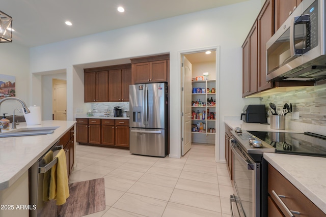 4576 W Agave Ave, Eloy, AZ 85131 - kitchen with stainless steel appliances, backsplash, a sink, and light countertops