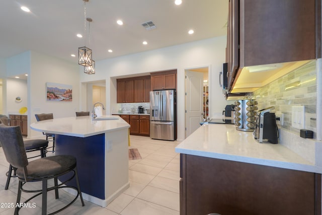 4576 W Agave Ave, Eloy, AZ 85131 - kitchen with visible vents, a breakfast bar, stainless steel appliances, light countertops, and a sink