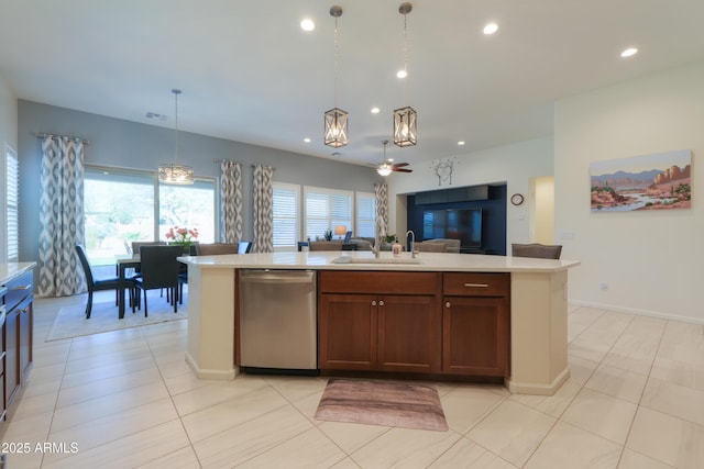 4576 W Agave Ave, Eloy, AZ 85131 - kitchen with a kitchen island with sink, open floor plan, light countertops, stainless steel dishwasher, and decorative light fixtures