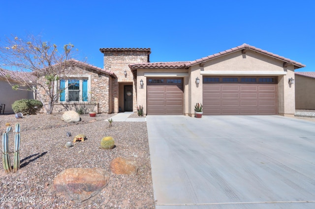 view of front of house with an attached garage, stone siding, a tiled roof, driveway, and stucco siding