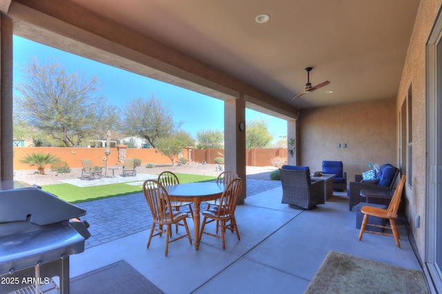 4576 W Agave Ave, Eloy, AZ 85131 - view of patio / terrace featuring a ceiling fan, outdoor dining area, a fenced backyard, and an outdoor living space