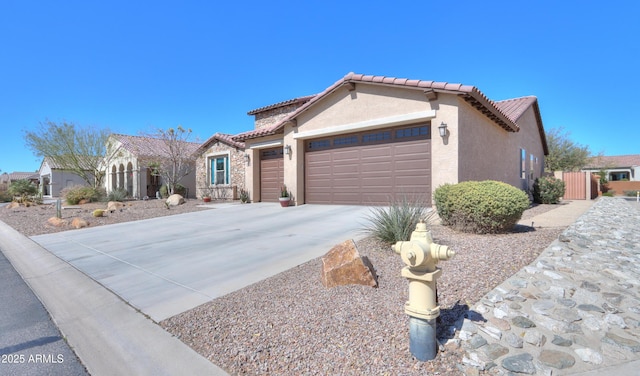 4576 W Agave Ave, Eloy, AZ 85131 - view of front of home featuring a garage, driveway, a tiled roof, and stucco siding