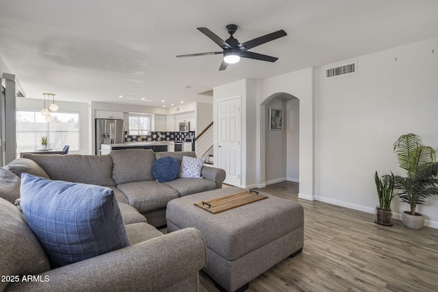 living room with hardwood / wood-style flooring and ceiling fan