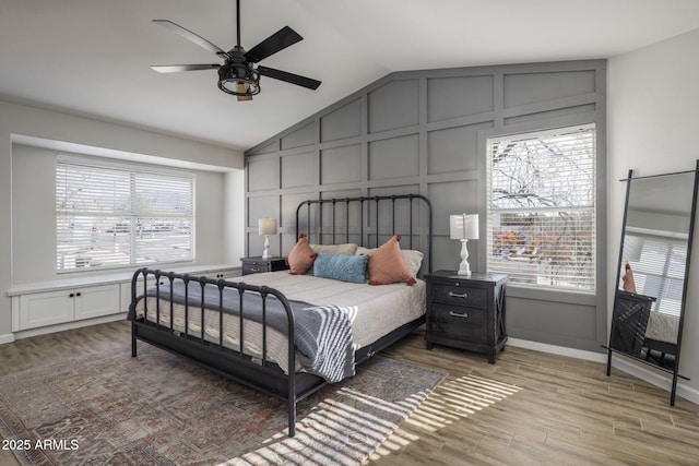 bedroom featuring lofted ceiling, wood-type flooring, and ceiling fan