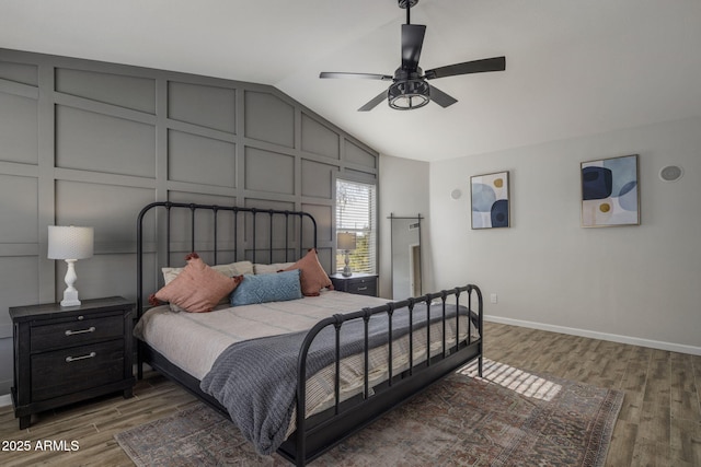 bedroom with vaulted ceiling, dark hardwood / wood-style floors, and ceiling fan