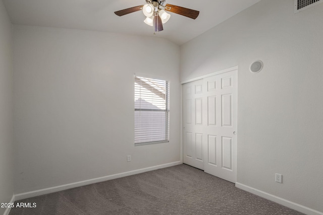 unfurnished bedroom featuring vaulted ceiling, carpet, ceiling fan, and a closet