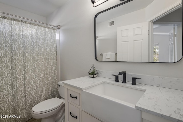 bathroom with vanity, toilet, and a shower with shower curtain