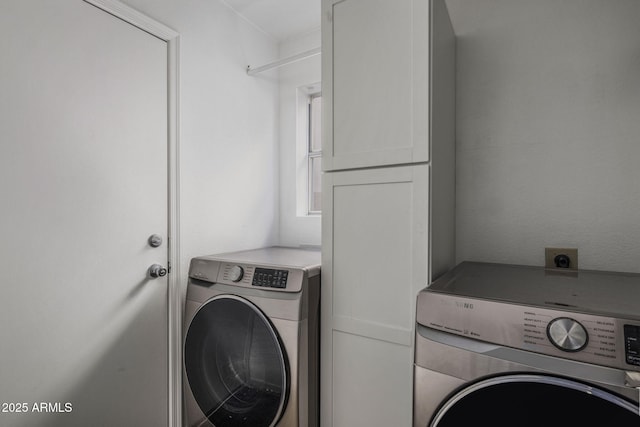 washroom with cabinets and washer / dryer