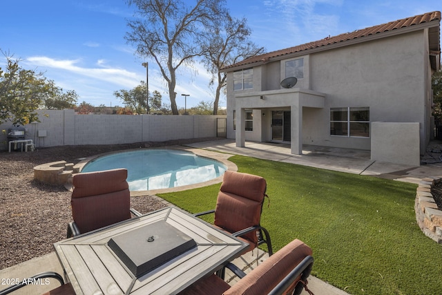 view of swimming pool with a yard and a patio