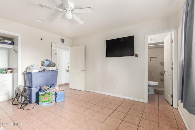 interior space with light tile patterned flooring, baseboards, visible vents, and ceiling fan