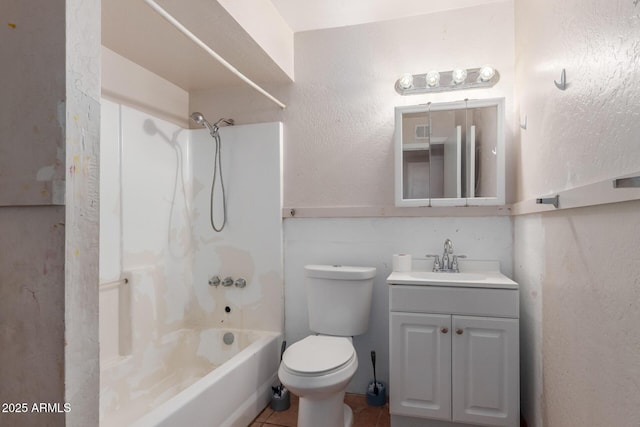 bathroom featuring toilet, bathtub / shower combination, a textured wall, tile patterned floors, and vanity