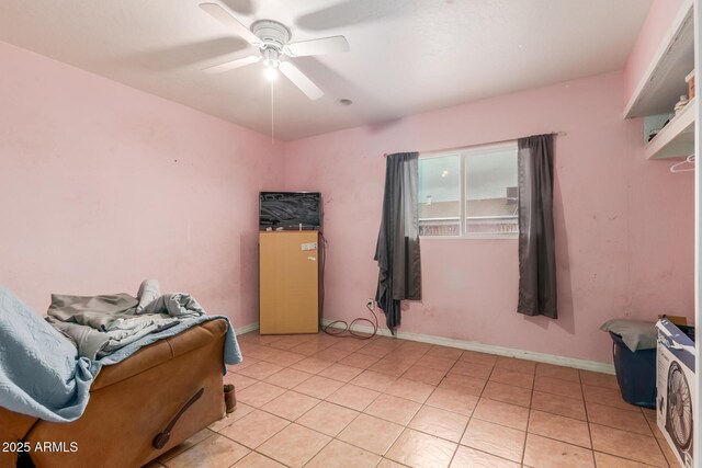 bedroom featuring light tile patterned flooring, baseboards, and ceiling fan