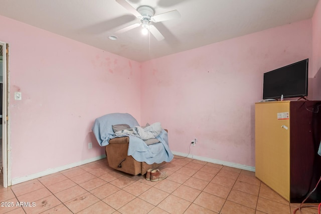 interior space featuring light tile patterned floors, baseboards, and ceiling fan