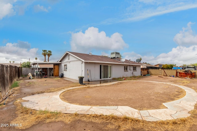 back of property featuring a patio area, cooling unit, and a fenced backyard