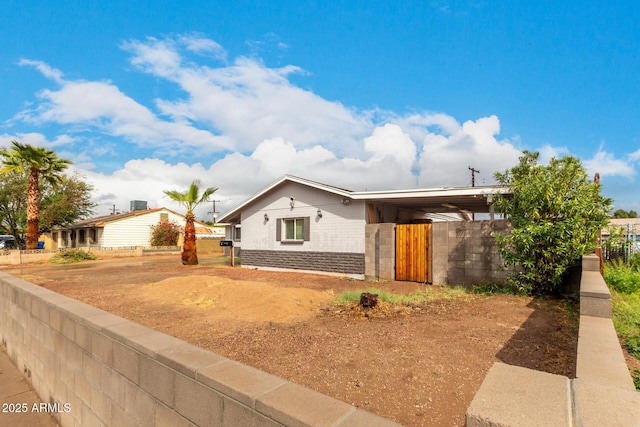 view of front of property with stone siding and fence