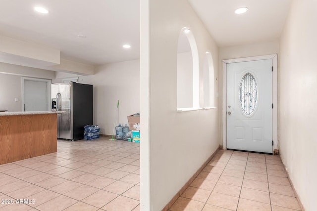 entryway with light tile patterned floors and recessed lighting