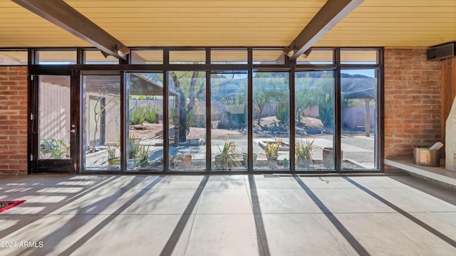 interior space featuring beam ceiling, a mountain view, and wood ceiling