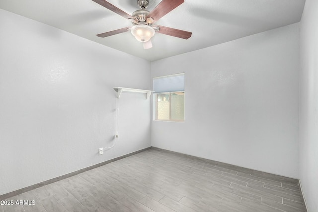 empty room featuring ceiling fan and light hardwood / wood-style flooring