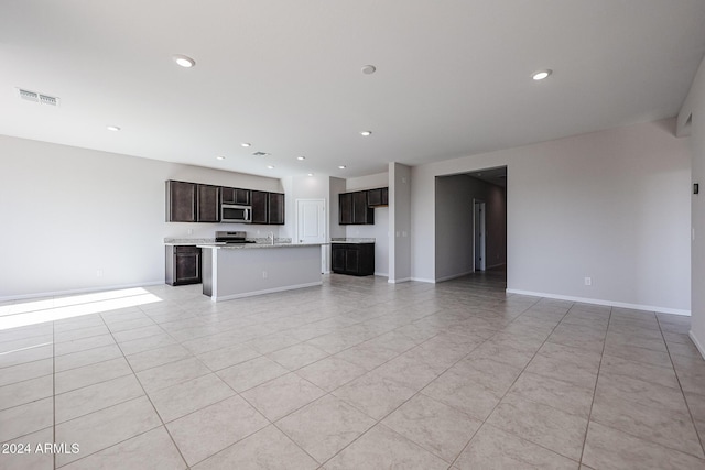 unfurnished living room featuring light tile patterned floors