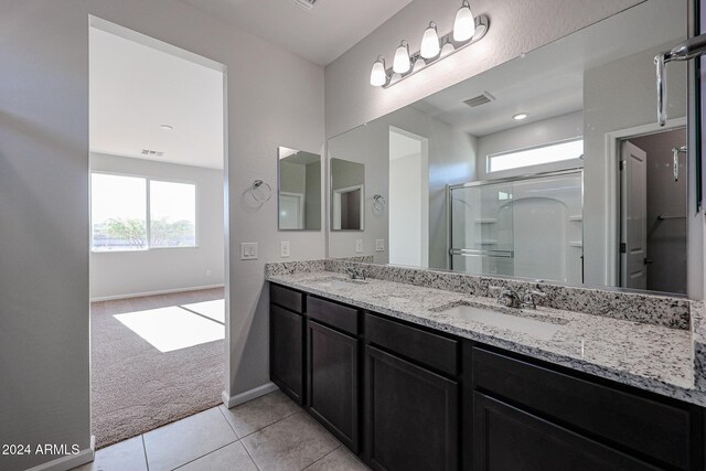 bathroom with vanity, tile patterned floors, and walk in shower