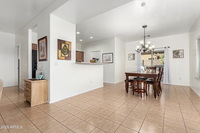 tiled dining room featuring a chandelier