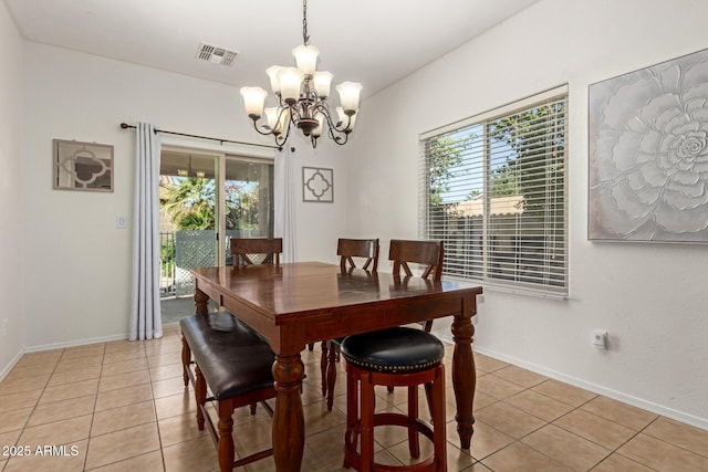 dining area featuring a notable chandelier and light tile patterned flooring