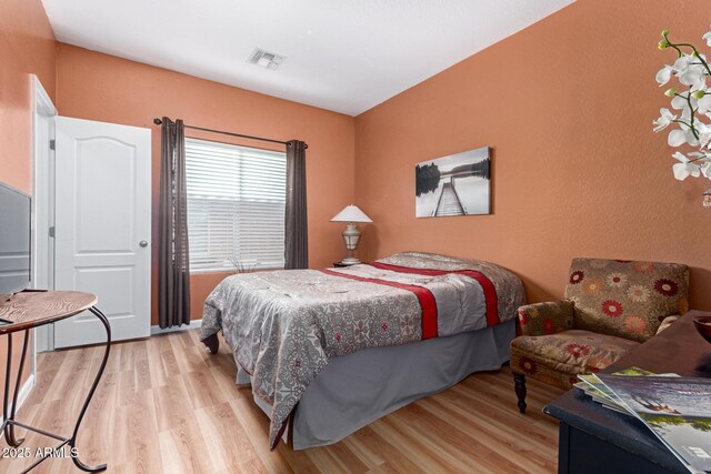 bedroom with light wood-type flooring