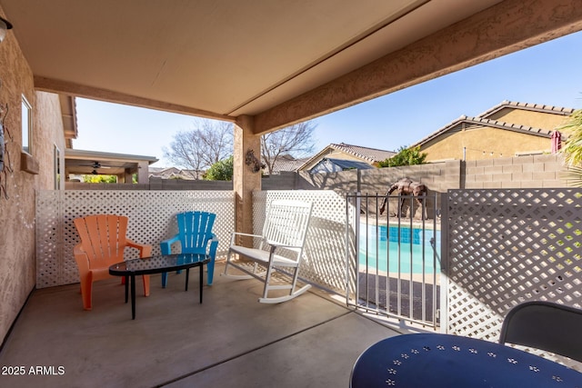 view of patio / terrace with a fenced in pool