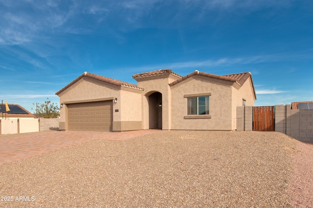 mediterranean / spanish-style home featuring a garage