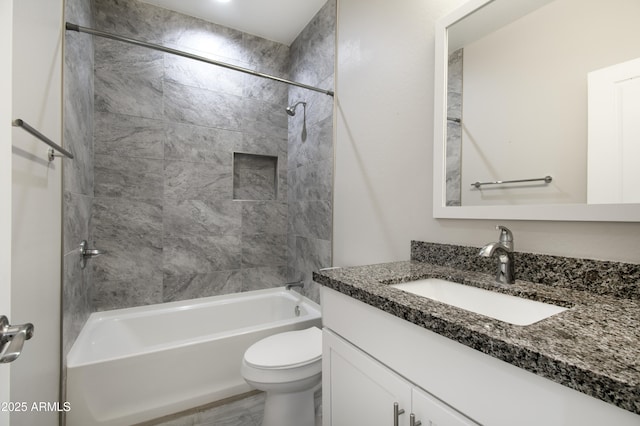 full bathroom with toilet, vanity, and tiled shower / bath combo