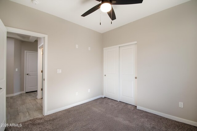 unfurnished bedroom featuring carpet, ceiling fan, and a closet