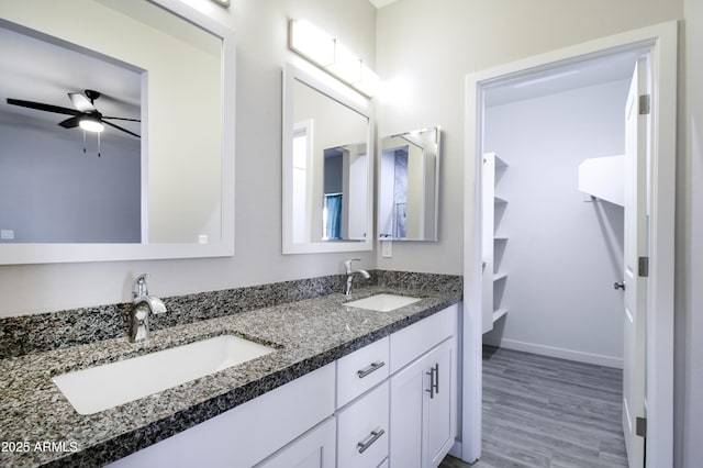 bathroom featuring vanity, hardwood / wood-style flooring, and ceiling fan