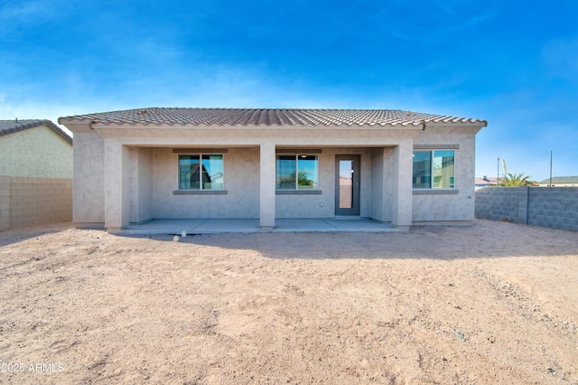 rear view of property featuring a patio area