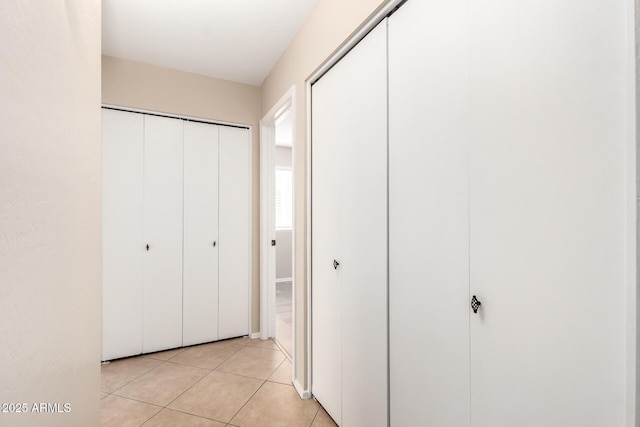 hallway with light tile patterned floors