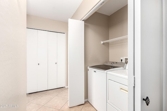 laundry area featuring laundry area, light tile patterned flooring, and independent washer and dryer